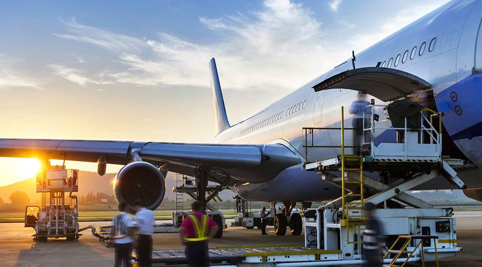A plane being loaded with cargo at an airport